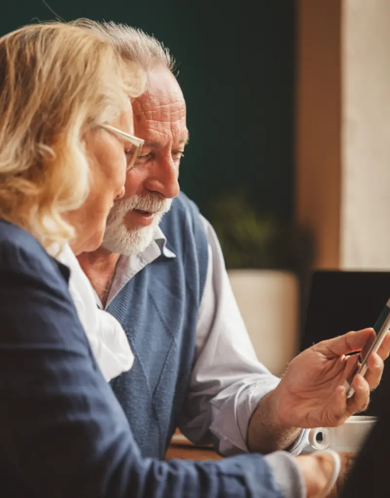 Older couple looking at a phone together